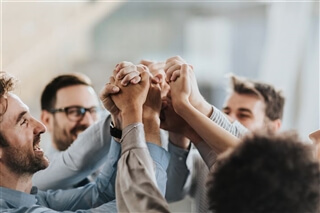 Markas stands for Inclusion & Diversity A group of people putting their hands up together - feeling strong together