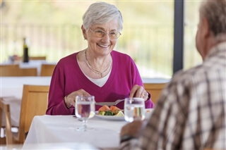 Fondazione SaluteVita - smiling lady eating lunch Fondazione SaluteVita - smiling lady eating lunch